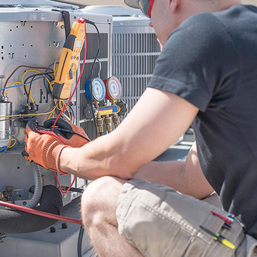 hvac-technician-working-on-gray-hvac-unit-dickinson-tx